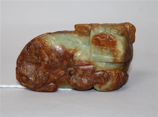 A Chinese greenish yellow and russet jade figure of a Buddhist lion, 17th/18th century 8cm.